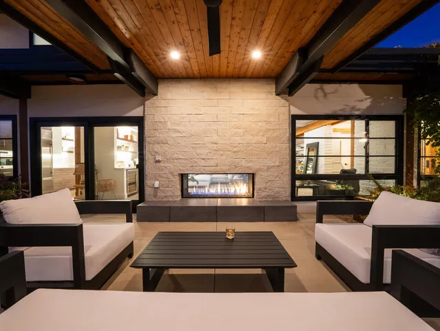 a view of a porch with furniture and a yard