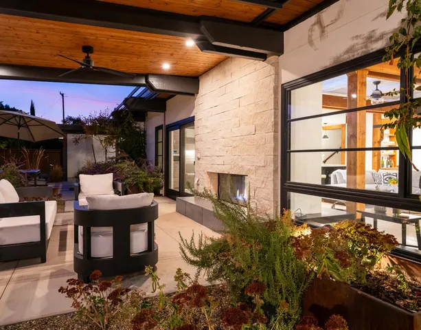 a view of a backyard with sitting area