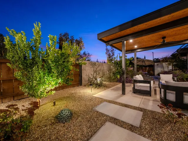 a view of a swimming pool with outdoor seating