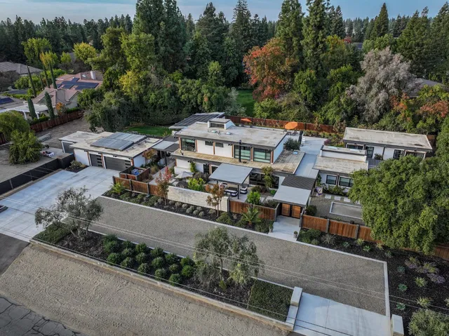an aerial view of a house with a garden and trees