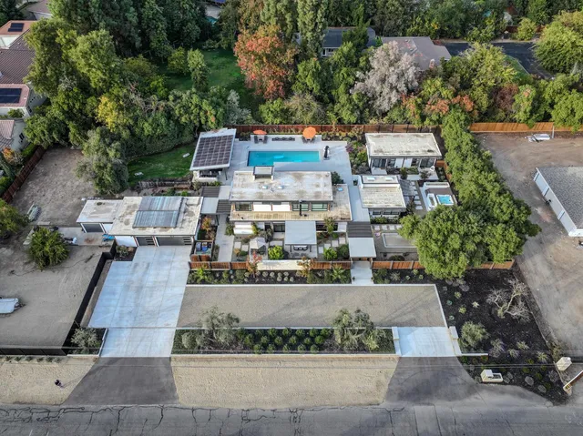 an aerial view of a large building and trees