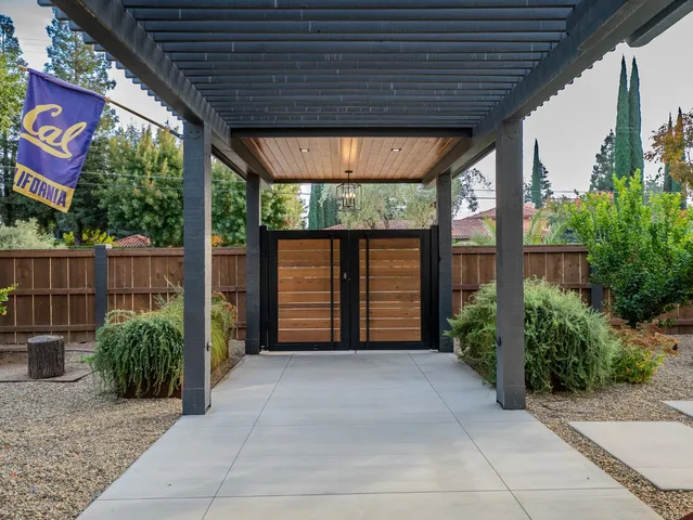 a view of a patio with table and chairs and potted plants