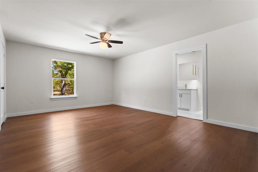 513 East Union Bower Road Irving, TX 75061 - Photo 14 of 34 Spacious room featuring wood-finish flooring, a ceiling fan, and a window