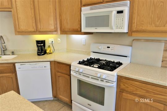 421 Mavis Court Ridgecrest, CA 93555 - Photo 7 of 33 a kitchen with a stove and a microwave
