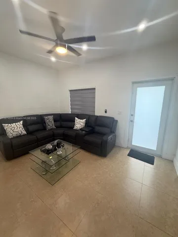a living room with furniture and a rug