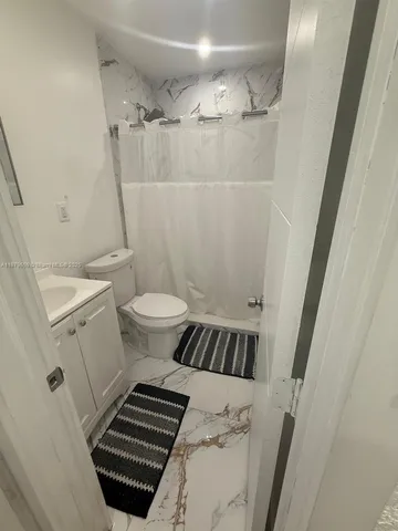 a living room with furniture and a gym machine