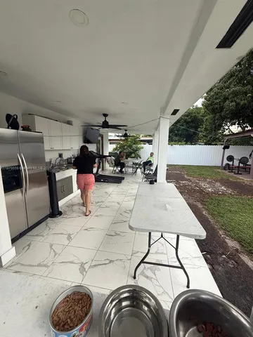 a view of a house with backyard porch and furniture