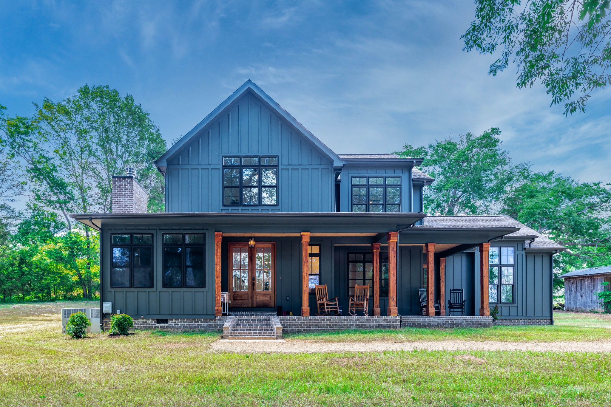 front view of a brick house with a yard