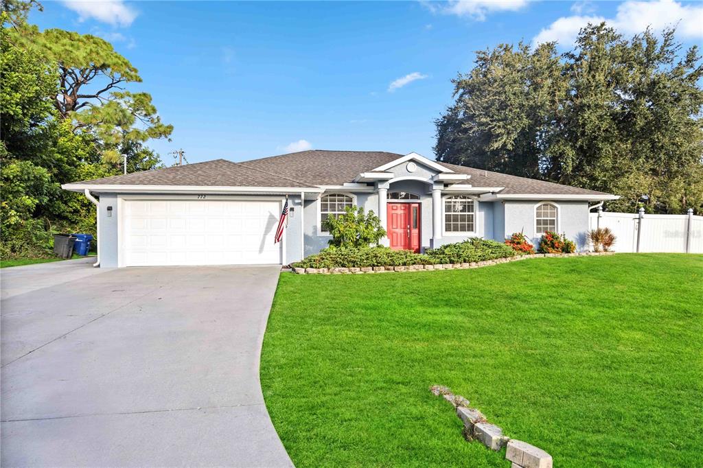 a front view of a house with a garden