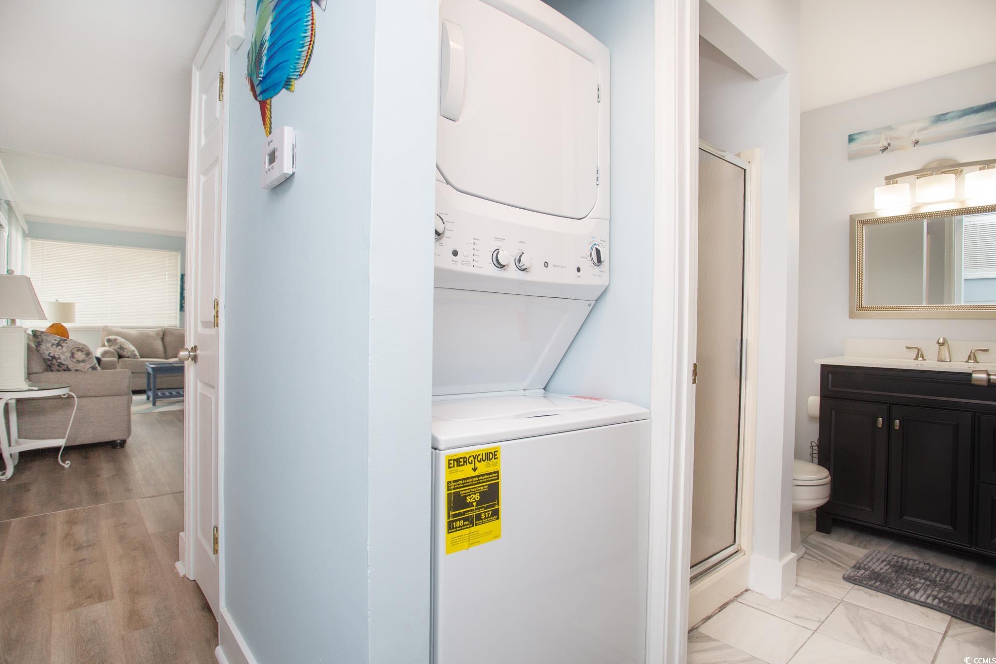351 Lake Arrowhead Road, Unit 25404 Myrtle Beach, SC 29572 - Photo 21 of 37 Washroom featuring sink, light hardwood / wood-style floors, and stacked washer / drying machine