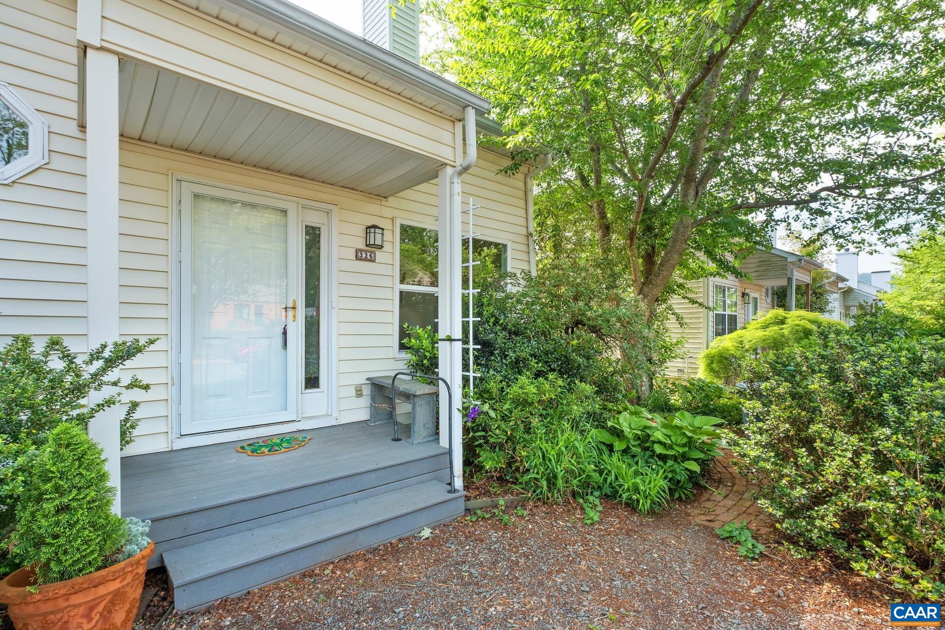 a wooden bench sitting in front of a house