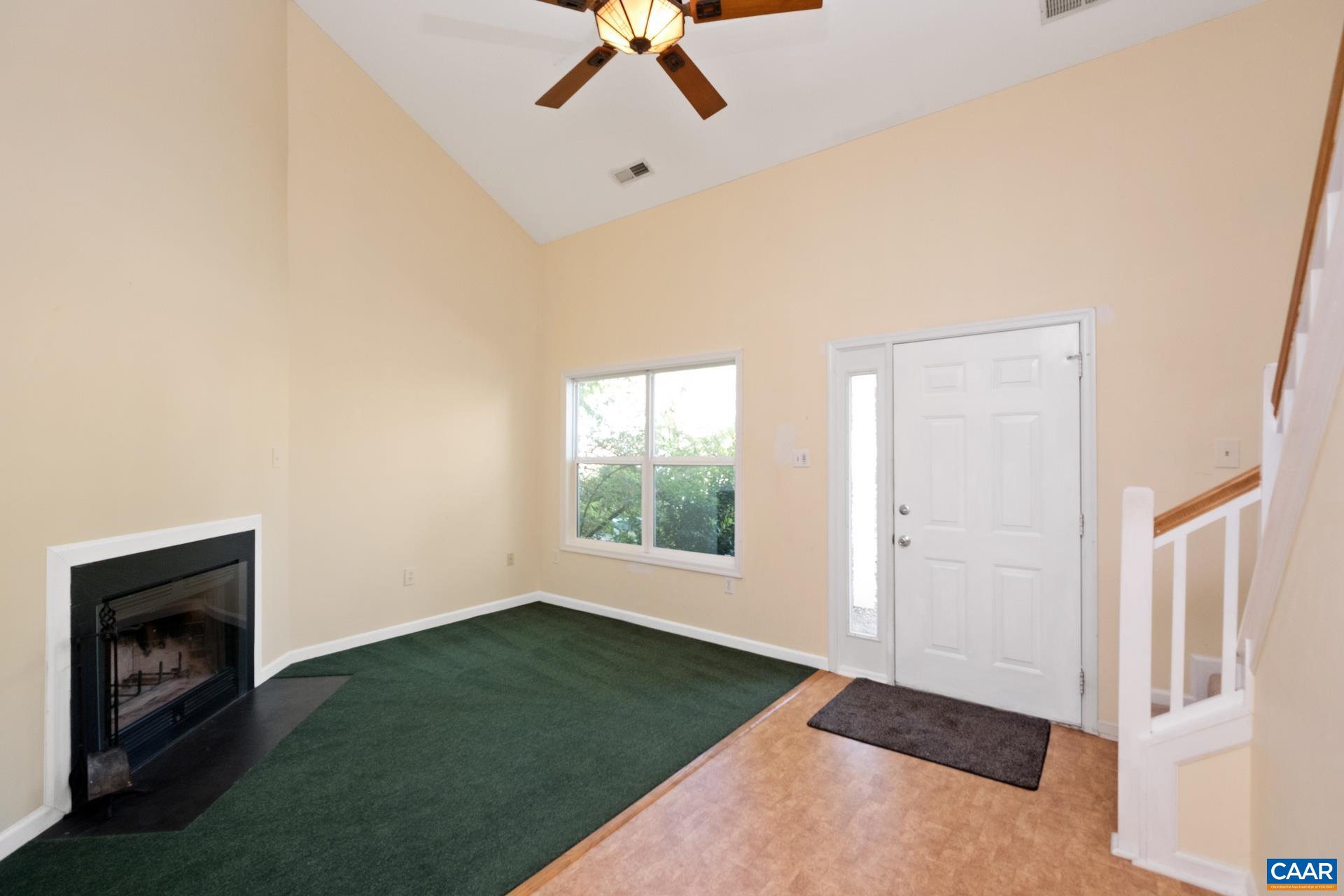 326 Riverside Avenue Charlottesville, VA 22902 - Photo 2 of 38 a view of an empty room with a fireplace and a window