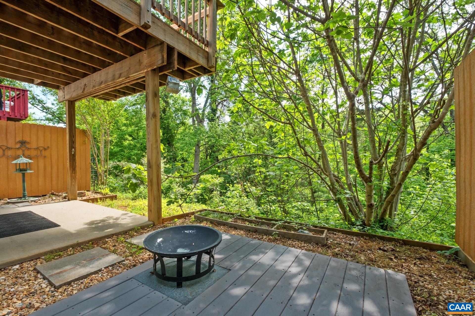326 Riverside Avenue Charlottesville, VA 22902 - Photo 36 of 38 a view of a backyard with table and chairs and wooden fence