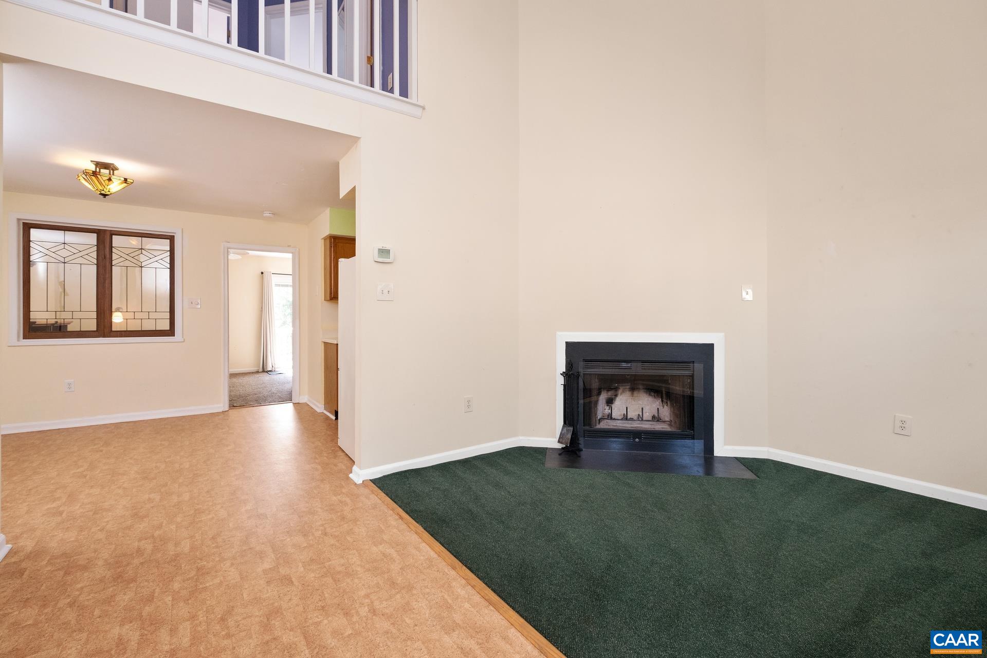 326 Riverside Avenue Charlottesville, VA 22902 - Photo 5 of 38 an empty room with a fireplace and wooden floor