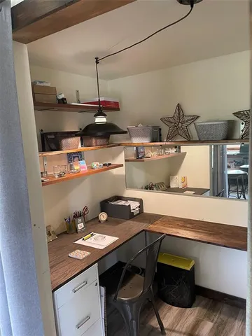 a kitchen with a sink a stove and wooden floor