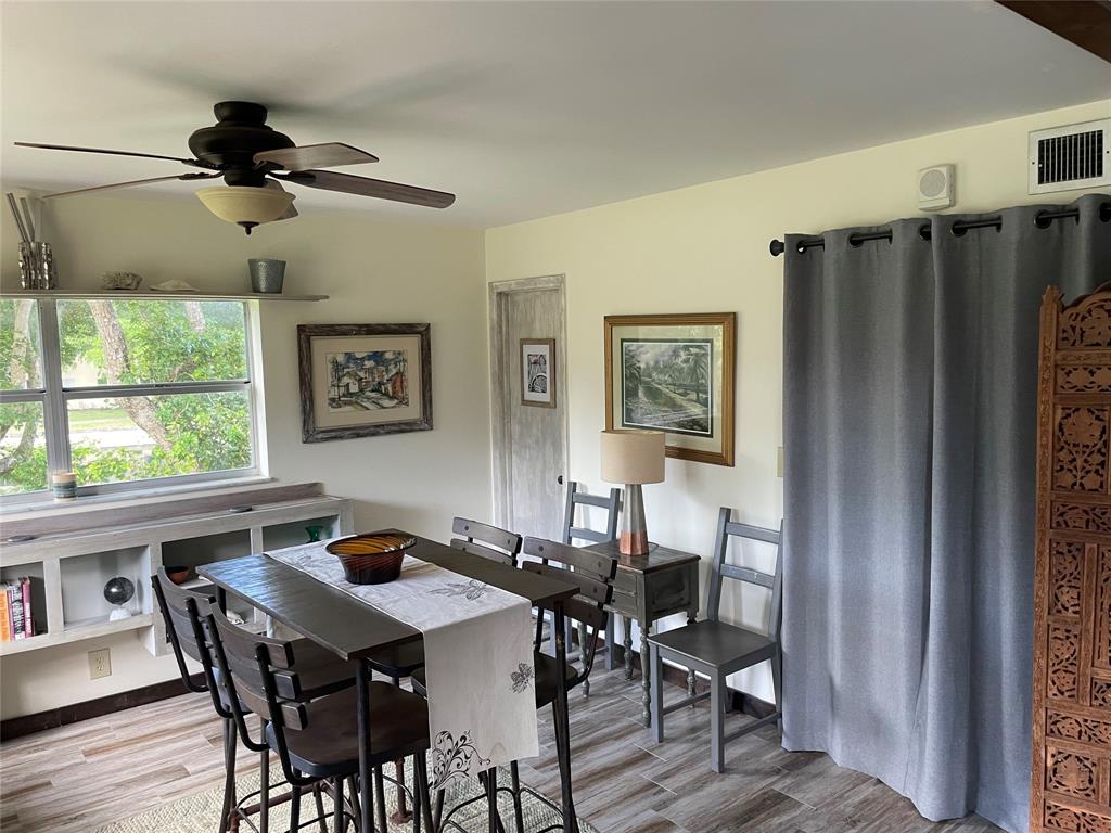 8838 West McNab Road, Unit 201 Tamarac, FL 33321 - Photo 8 of 20 a view of a dining room with furniture window and wooden floor