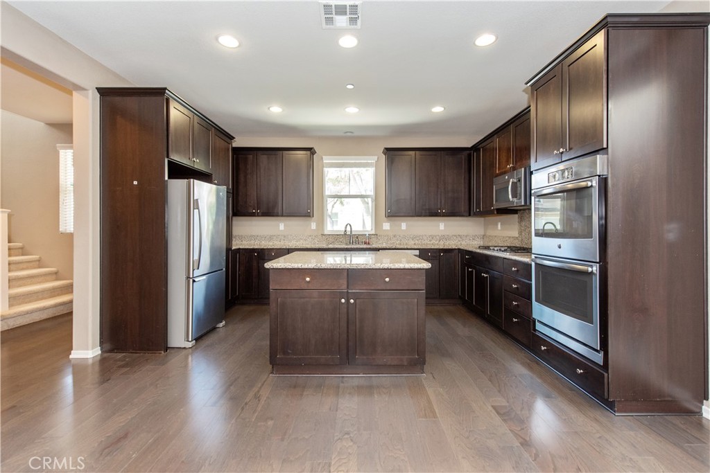 148 Compass Irvine, CA 92618 - Photo 3 of 15 a kitchen with stainless steel appliances granite countertop a refrigerator sink and cabinets