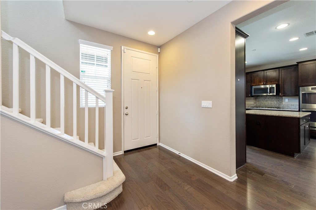 148 Compass Irvine, CA 92618 - Photo 7 of 15 a view of a kitchen with a sink and a refrigerator