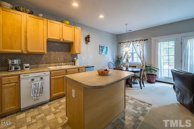 a kitchen with sink a window and dining table