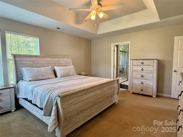 a bedroom with a bed and a ceiling fan