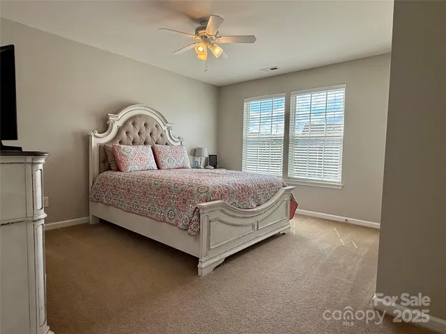 a bedroom with a bed dresser and a window
