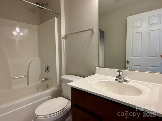 a bathroom with a sink toilet vanity and shower