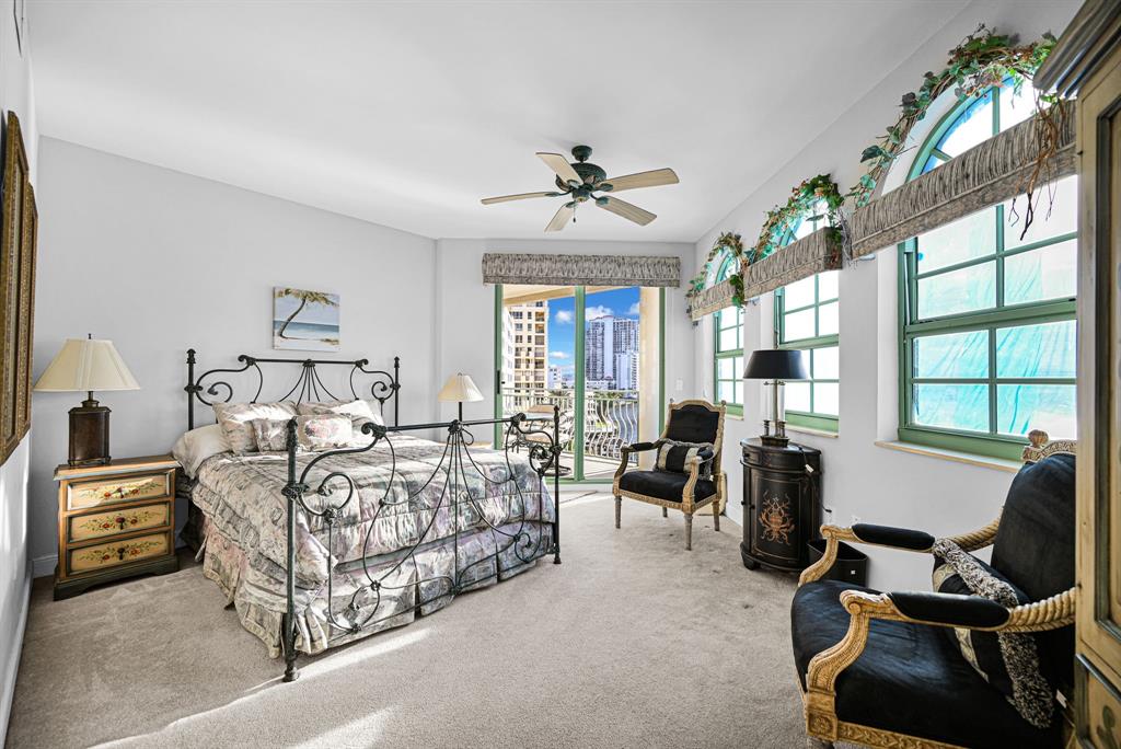 301 North Birch Road, Unit 6S Fort Lauderdale, FL 33304 - Photo 12 of 20 a bedroom with a bed and a chandelier