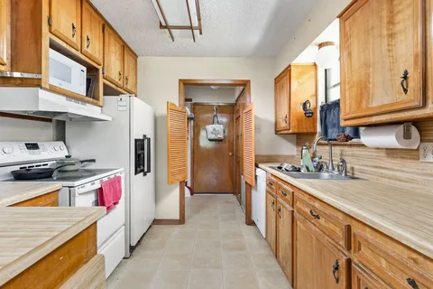 a kitchen with stainless steel appliances granite countertop a sink and a stove