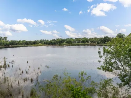 a view of a lake with houses in the back
