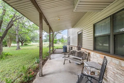 a backyard of a house with outdoor seating