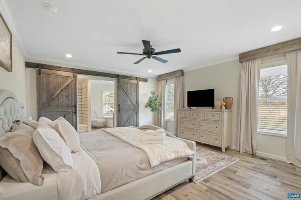 a bedroom with a bed and glass window
