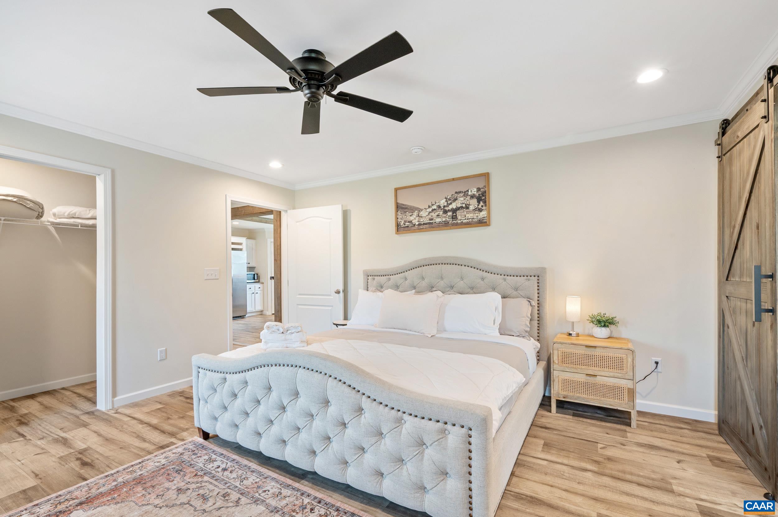 1600 Rock Spring Road Shipman, VA 22971 - Photo 23 of 74 a bedroom with a large bed and a chandelier