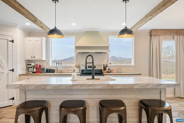 a kitchen with a sink a stove and cabinets