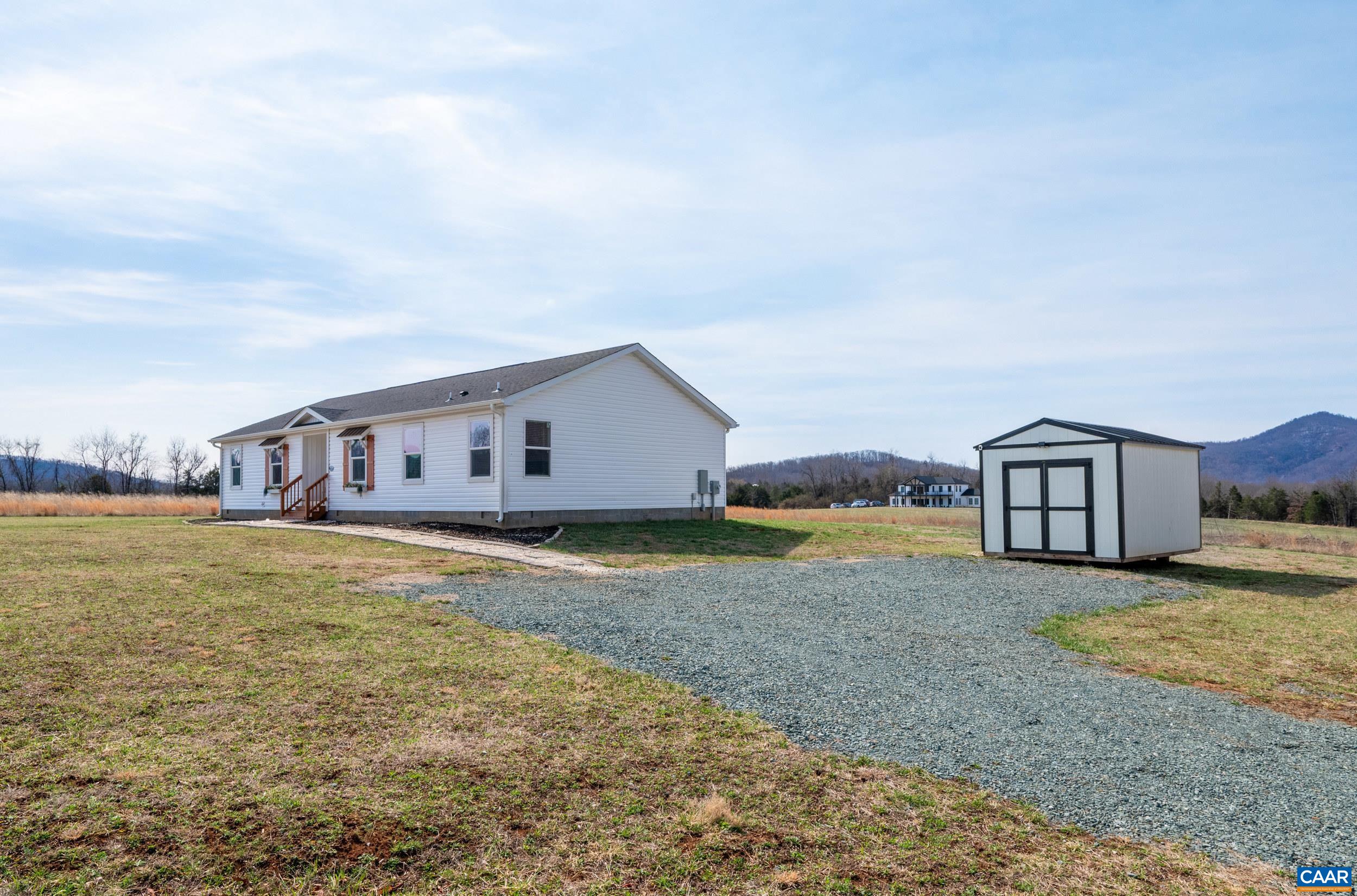 1600 Rock Spring Road Shipman, VA 22971 - Photo 55 of 74 a big house with a big yard and large trees