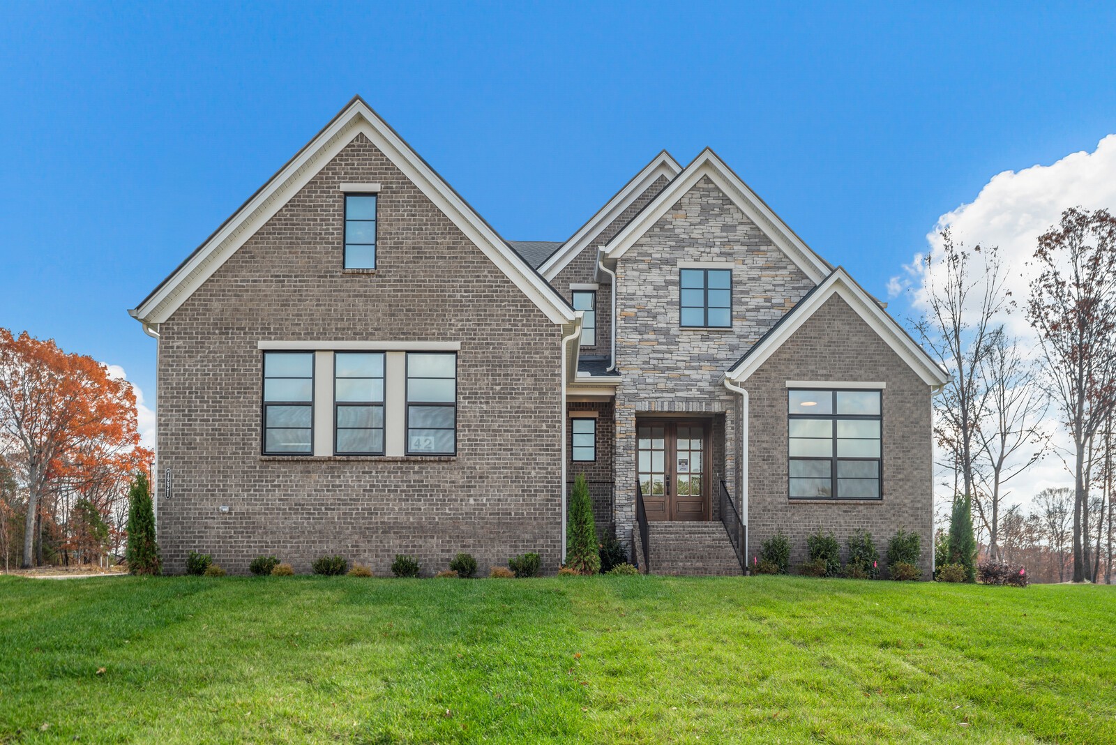 a front view of a house with a yard