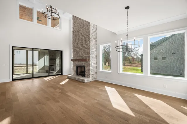 a view of a room with wooden floor and staircase
