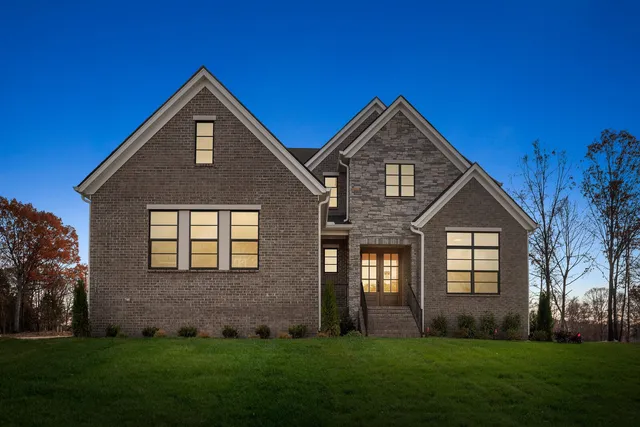 a front view of a house with a yard