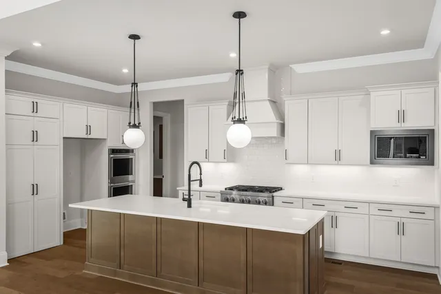 a kitchen with stainless steel appliances a refrigerator sink and cabinets