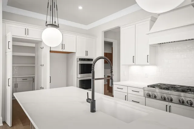 a kitchen with kitchen island a sink stainless steel appliances and cabinets