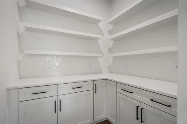 a kitchen with a sink a stove and a wooden floor