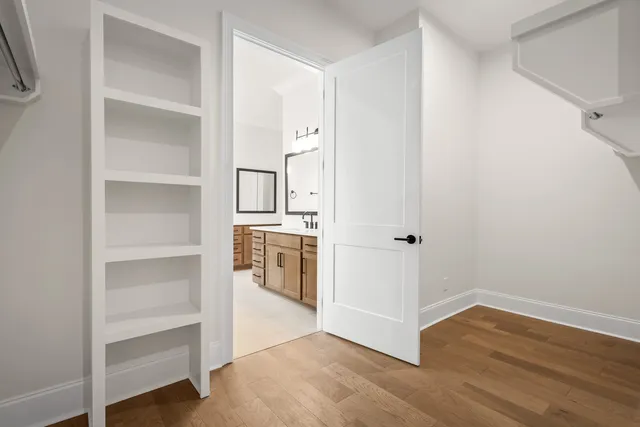a kitchen with granite countertop white cabinets and sink
