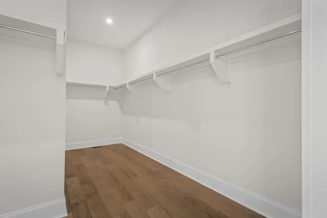 a view of a livingroom with wooden floor and ceiling fan