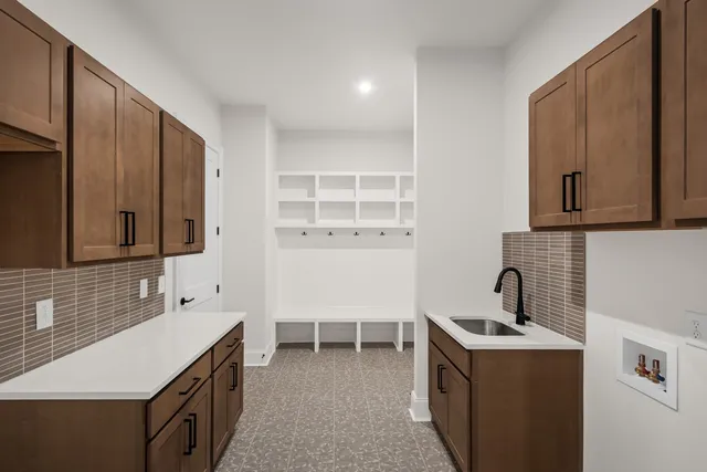 a view of empty room with a kitchen
