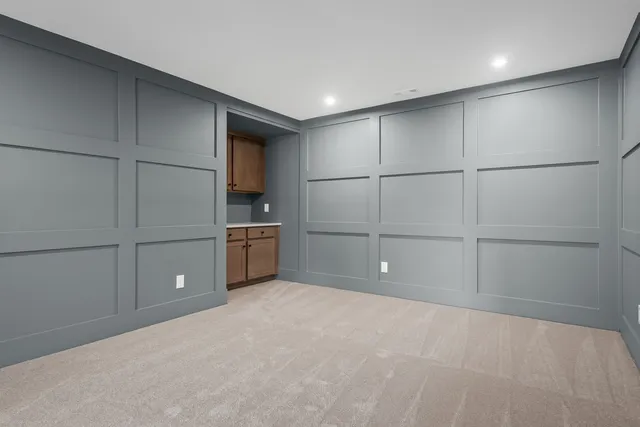 an empty room with a fan and a window