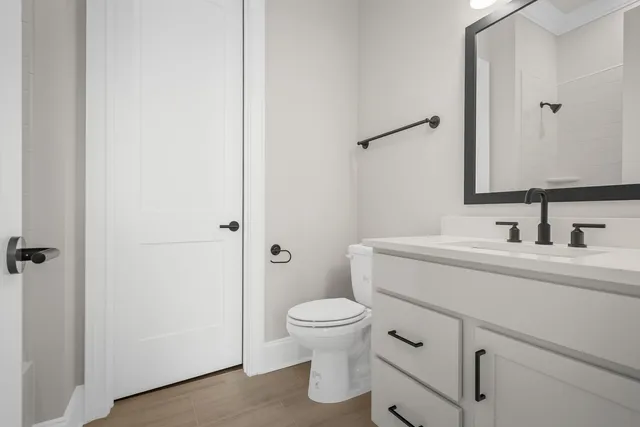 a bathroom with a tub sink and mirror