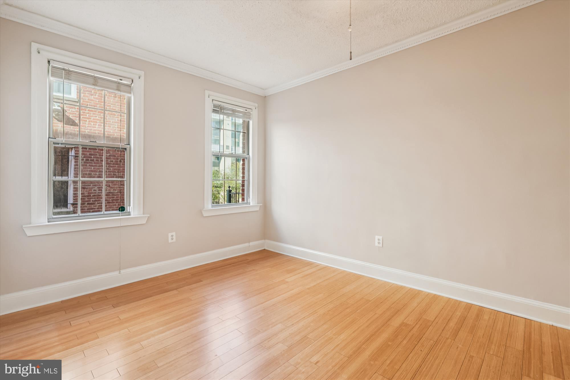 1401 Columbia Road Northwest, Unit 209 Washington, DC 20009 - Photo 16 of 34 an empty room with wooden floor and windows