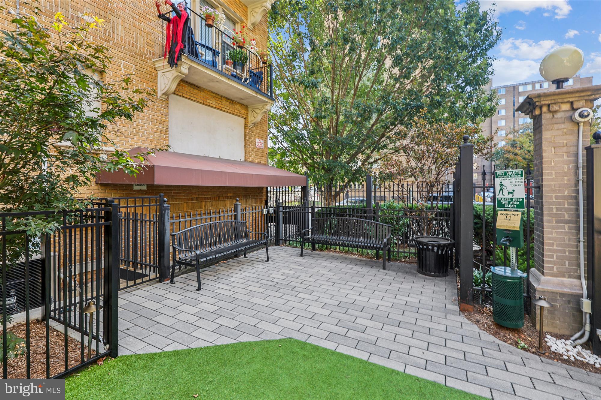 1401 Columbia Road Northwest, Unit 209 Washington, DC 20009 - Photo 33 of 34 a view of a house with a yard and wooden fence