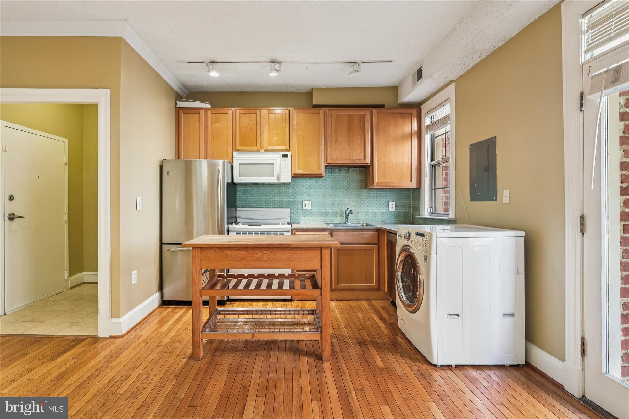 1401 Columbia Road Northwest, Unit 209 Washington, DC 20009 - Photo 5 of 34 a kitchen with stainless steel appliances granite countertop a refrigerator a stove and a wooden floors