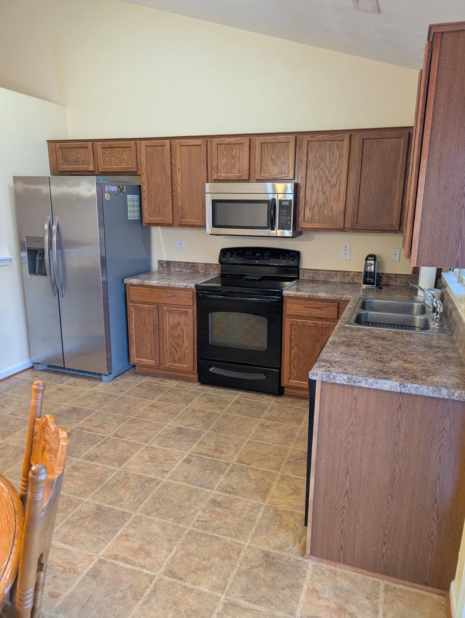 1126 Gearhart Road Southeast Roanoke, VA 24014 - Photo 3 of 13 a kitchen with stainless steel appliances granite countertop a sink stove and refrigerator