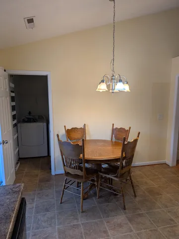 a dining room with furniture and window